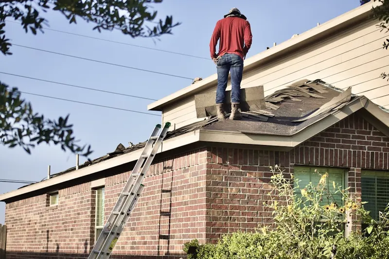 Professional roofer working on a residential roof in Orchards of Linthicum